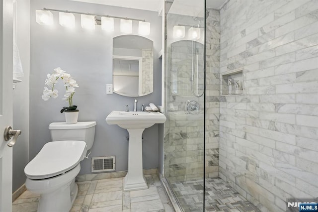 bathroom with visible vents, a shower stall, toilet, and marble finish floor