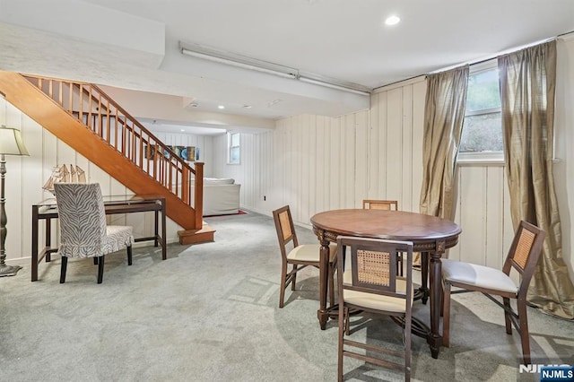 carpeted dining area with recessed lighting and stairway