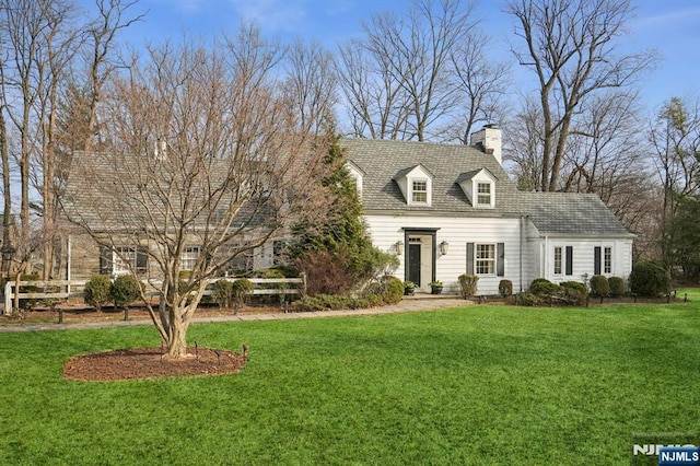 cape cod house with a chimney and a front lawn