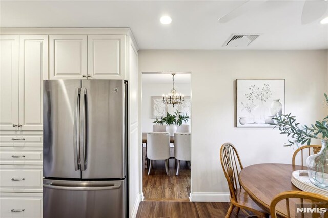 kitchen featuring visible vents, recessed lighting, dark wood-style flooring, freestanding refrigerator, and white cabinetry