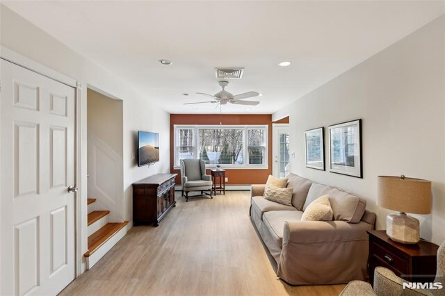 living room featuring stairway, a ceiling fan, visible vents, recessed lighting, and light wood-type flooring