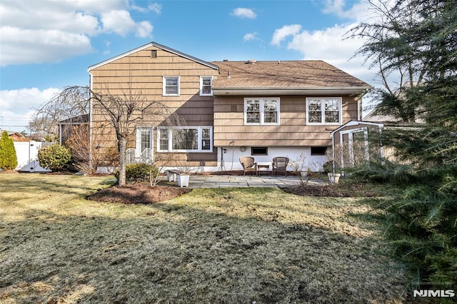 rear view of property with a yard, a patio area, and fence