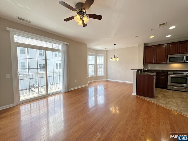 kitchen featuring light wood finished floors, visible vents, and appliances with stainless steel finishes