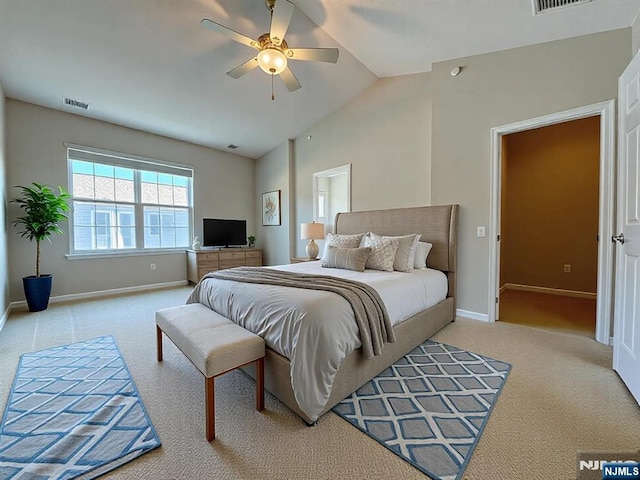 carpeted bedroom with visible vents, baseboards, lofted ceiling, and a ceiling fan