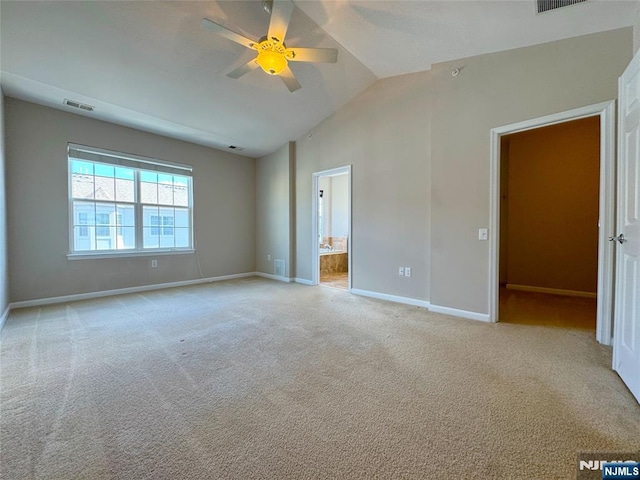 unfurnished bedroom with visible vents, carpet floors, lofted ceiling, and baseboards