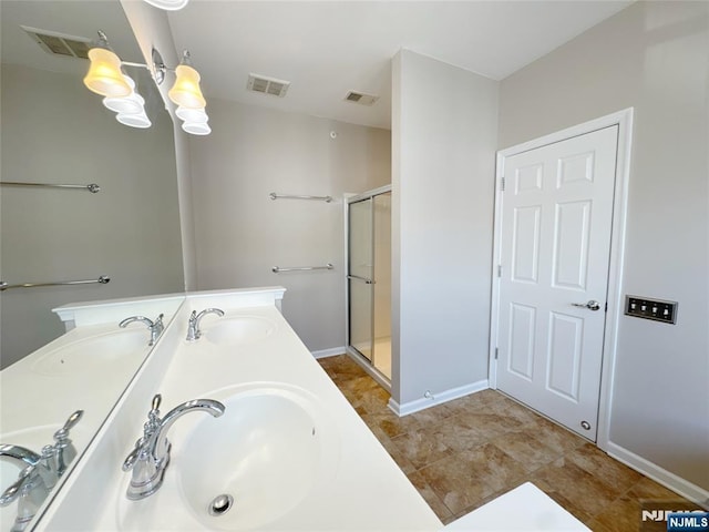 bathroom featuring a sink, visible vents, and a shower stall