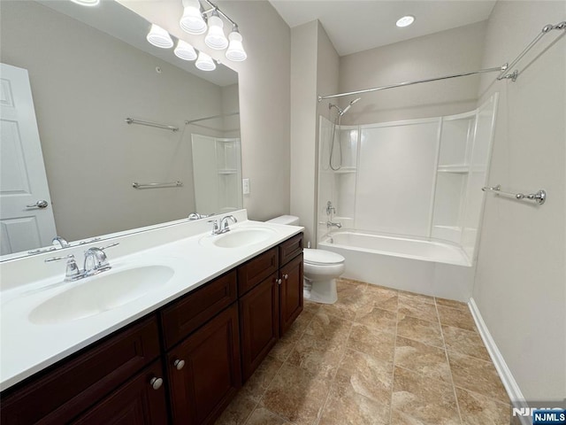 bathroom with double vanity, toilet, shower / bathtub combination, and a sink