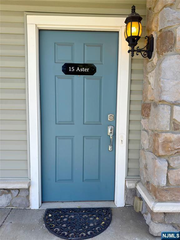 view of exterior entry featuring stone siding