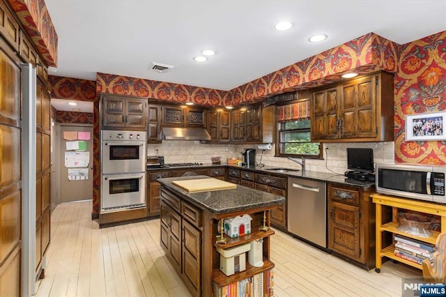 kitchen with visible vents, wallpapered walls, under cabinet range hood, appliances with stainless steel finishes, and open shelves