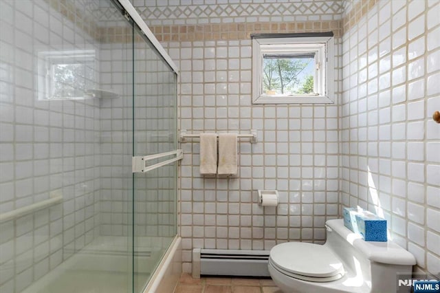 bathroom with tile patterned floors, baseboard heating, tile walls, and toilet