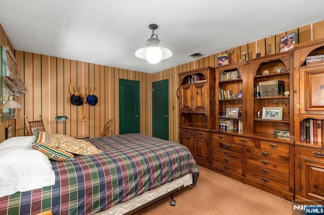 bedroom featuring visible vents, light colored carpet, and wallpapered walls