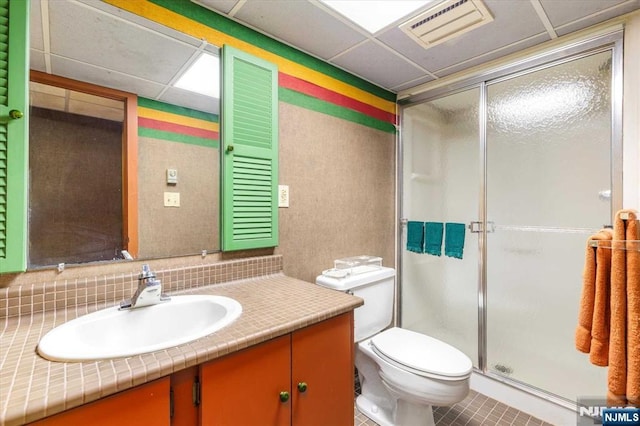 bathroom featuring visible vents, toilet, and a stall shower