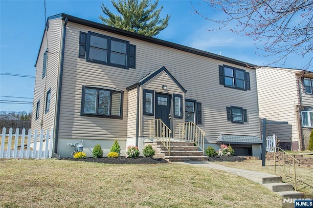 view of front of home featuring a front lawn and fence