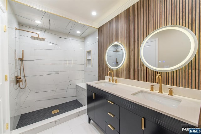 full bathroom with a marble finish shower, recessed lighting, double vanity, and a sink