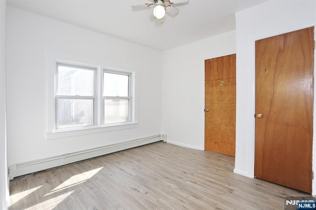 unfurnished bedroom with light wood-style floors, baseboards, baseboard heating, and a ceiling fan