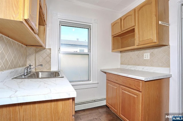 kitchen with a sink, baseboard heating, and light countertops