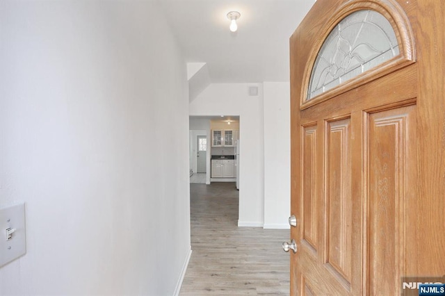 entryway featuring light wood-style flooring and baseboards