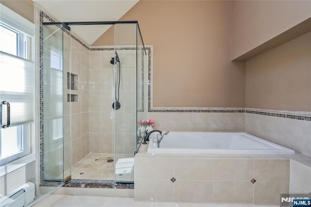 full bathroom featuring a baseboard heating unit, a garden tub, and a shower stall