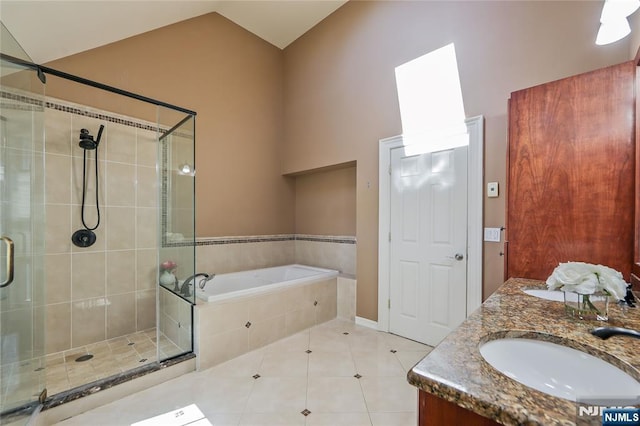 bathroom featuring a garden tub, lofted ceiling, a stall shower, a sink, and tile patterned floors