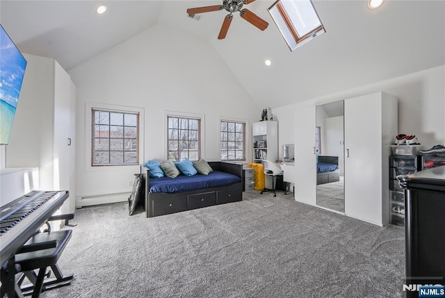 bedroom with a ceiling fan, carpet floors, high vaulted ceiling, a skylight, and a baseboard heating unit