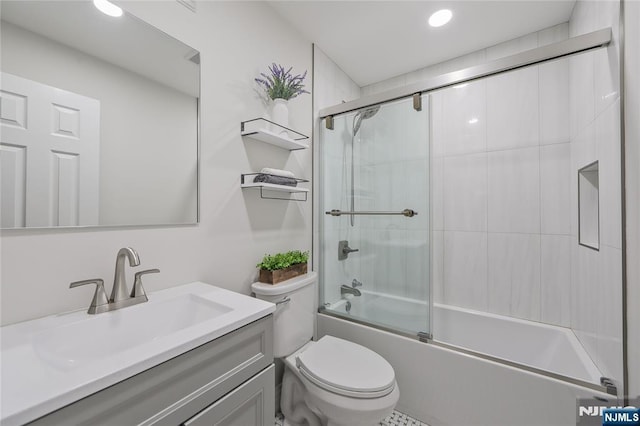 full bathroom with recessed lighting, bath / shower combo with glass door, toilet, and vanity