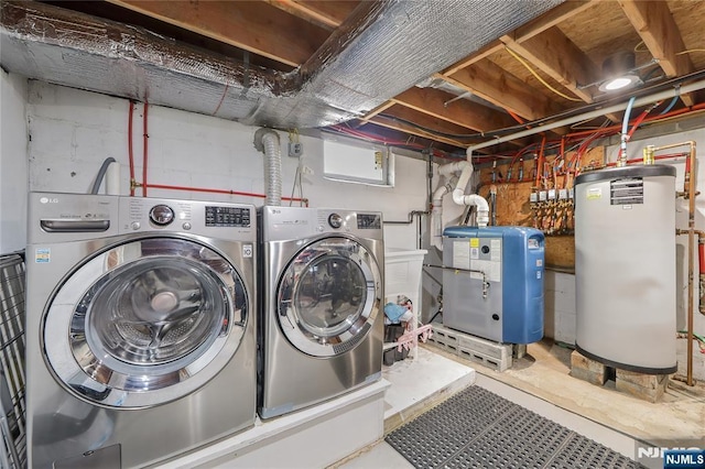 laundry room with laundry area, gas water heater, a heating unit, and independent washer and dryer