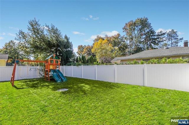 view of yard featuring a playground and a fenced backyard