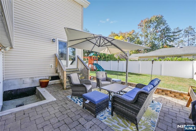 view of patio / terrace with a fenced backyard and a playground