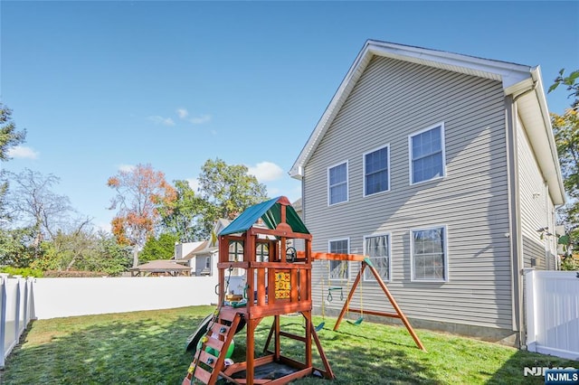 view of jungle gym featuring a fenced backyard and a yard