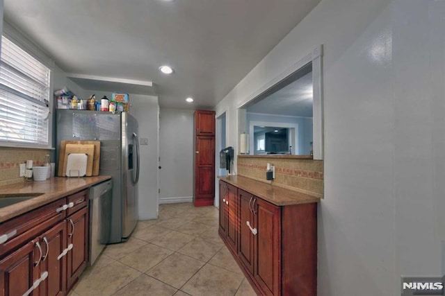 kitchen with light tile patterned floors, recessed lighting, backsplash, and dishwasher