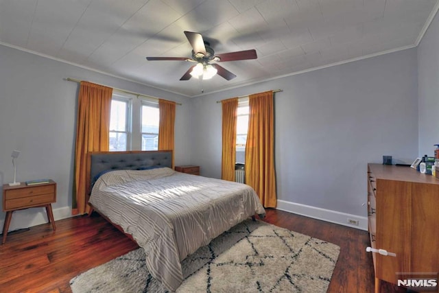 bedroom with multiple windows, baseboards, ornamental molding, and wood finished floors