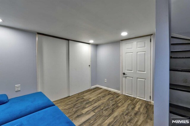 below grade area featuring recessed lighting, baseboards, and wood finished floors