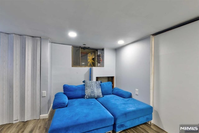 living area with recessed lighting and wood finished floors