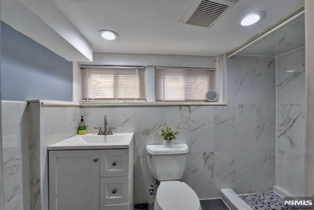 full bath with visible vents, toilet, walk in shower, and vanity