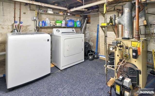 laundry area with laundry area, independent washer and dryer, and a heating unit