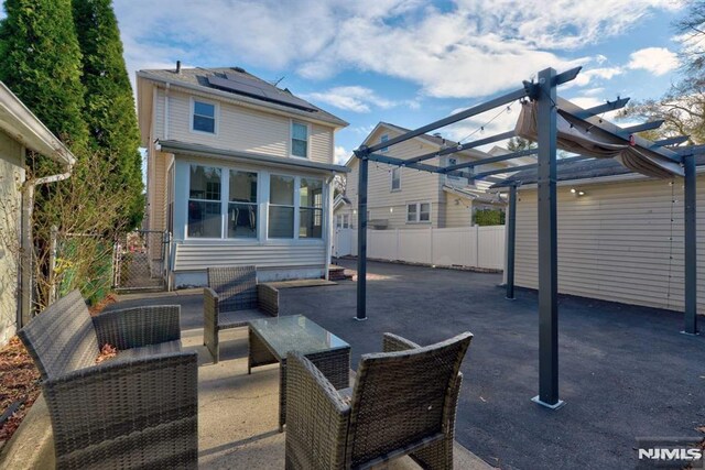 view of patio / terrace featuring an outdoor hangout area, fence, and a pergola