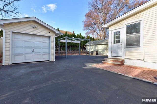 detached garage featuring driveway