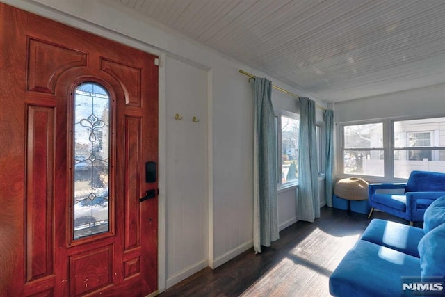 entrance foyer with baseboards and wood finished floors