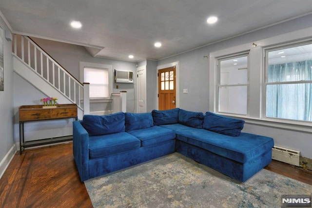 living area with stairway, wood finished floors, baseboards, recessed lighting, and baseboard heating