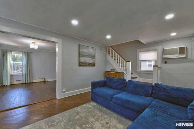 living room featuring a baseboard heating unit, baseboards, stairs, recessed lighting, and wood finished floors