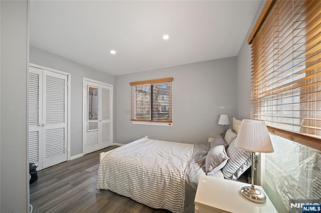 bedroom with recessed lighting, baseboards, multiple closets, and wood finished floors