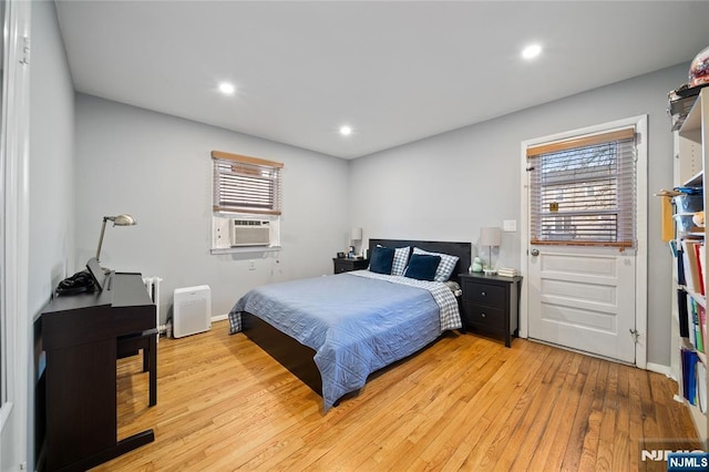 bedroom with recessed lighting, cooling unit, baseboards, and light wood-style flooring