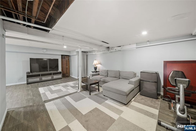 living area featuring baseboards and wood finished floors