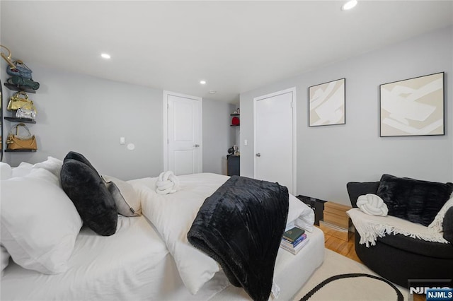 bedroom with a closet, recessed lighting, and wood finished floors