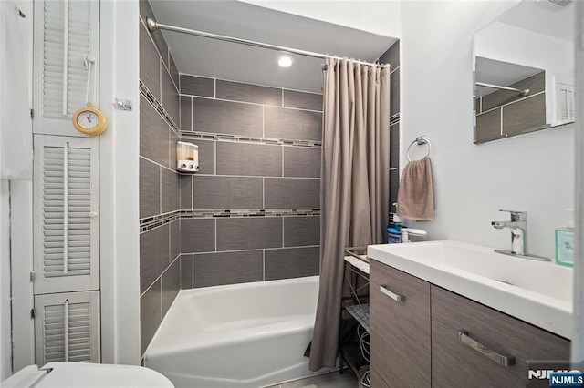 full bath with vanity, toilet, and shower / tub combo with curtain