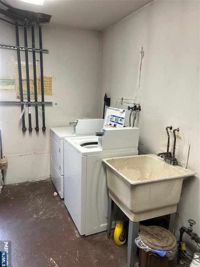 washroom featuring washer and clothes dryer and a sink