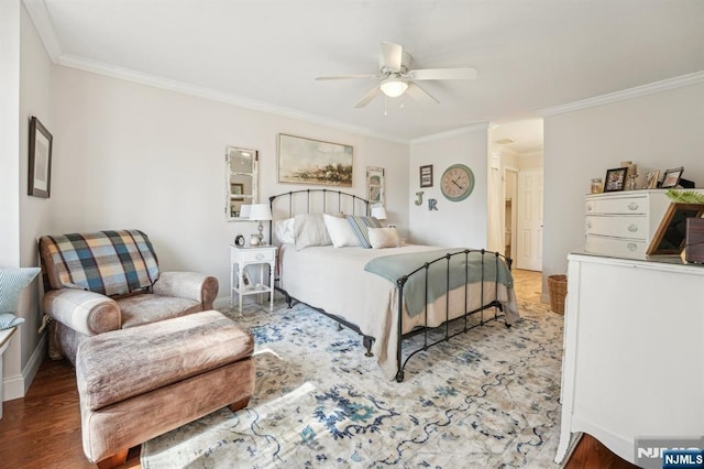 bedroom featuring ceiling fan, wood finished floors, and crown molding