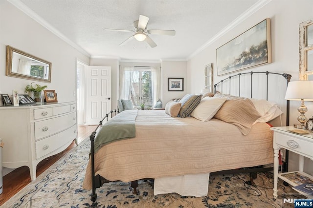 bedroom with ceiling fan, a textured ceiling, wood finished floors, and ornamental molding