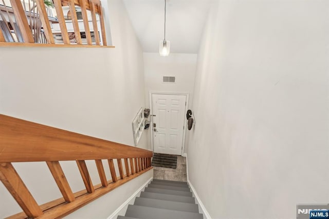 stairs featuring visible vents and baseboards