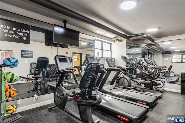 exercise room with a wealth of natural light and baseboards